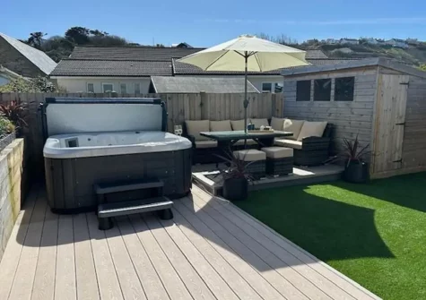 The decked terrace, alfresco dining area & hot tub at Pebbles, Portreath