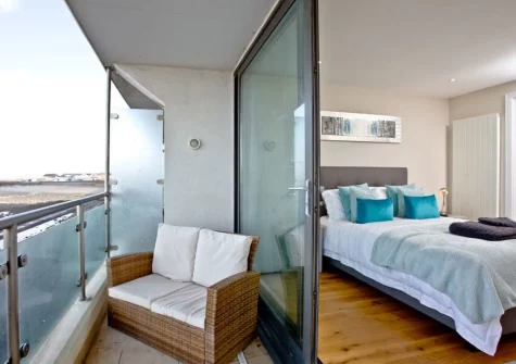 Bedroom #1 patio doors open on to the balcony & outdoor sitting area at Pebbles, Westward Ho!