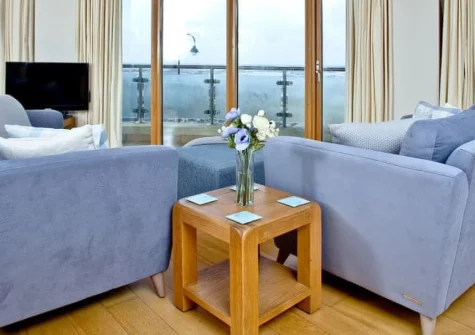 Pebbles, Westward Ho! is a stunning ground floor apartment in the landmark Horizon View building, offering breathtaking Atlantic views from a wraparound balcony, contemporary interiors, and direct access to Golden Bay's sandy beach.