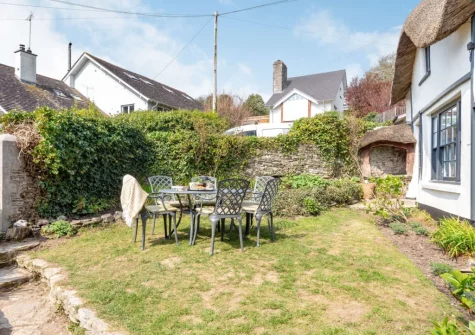 The alfresco dining area & enclosed traditional cottage garden at Peep O Day, West Buckland