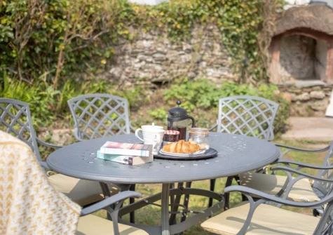 The alfresco dining area & enclosed traditional cottage garden at Peep O Day, West Buckland