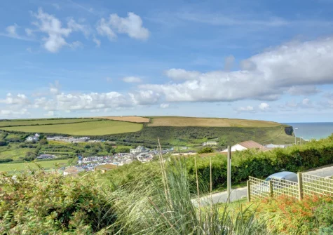 Enjoy far reaching countryside & sea views from the front decked patio & outdoor sitting area at Pen Y Mor, Mawgan Porth