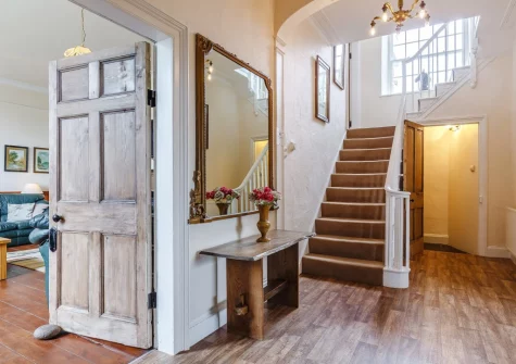 The entrance hallway & stairs up to the first floor at Pendavey Farm House, Sladesbridge