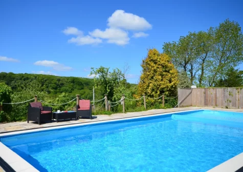 The heated outdoor swimming pool at Pendavey Farm House, Sladesbridge