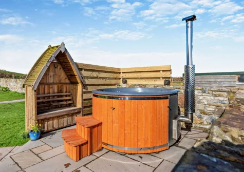 The wood-fired hot tub, patio & enclosed garden at Penhill Tack Room, Fremington