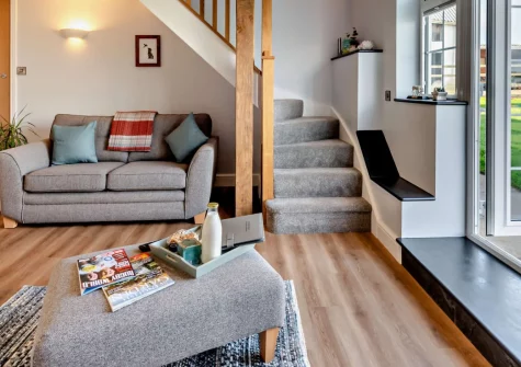 Penhill Tack Room, Fremington is a stylish one-bedroom riverside retreat with a wood-fired hot tub, exposed beams, and sweeping River Taw views — a perfect base for exploring North Devon's beaches, villages, and family attractions.