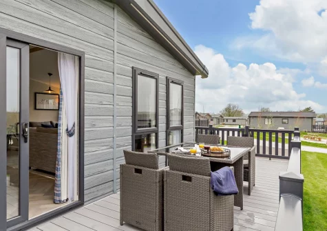 The wrap-around decked terrace & alfresco dining area at Penmarlam Lodge, Lanteglos