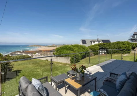 The patio, outdoor sitting area & lawned garden at Pentire Beach House, Newquay