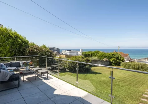 The patio, outdoor sitting area & lawned garden at Pentire Beach House, Newquay