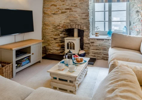 Petroc, Looe is a characterful Grade II-listed fisherman's cottage in the heart of East Looe, brimming with beamed ceilings and feature stone walls, positioned just moments from the sandy beach, bustling harbour, and spectacular coastal path.