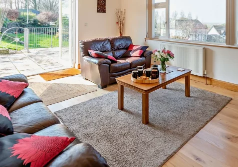 Pilot's View, Northam is a modern detached bungalow set in peaceful countryside near Appledore, boasting panoramic sea views from an enclosed patio, contemporary interiors, and easy access to North Devon's golden beaches and coastal paths.