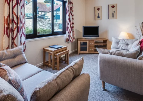 Pioneer Apartment No 7, Beer is a welcoming ground-floor apartment in the heart of this charming fishing village, featuring open-plan living spaces, comfortable accommodation for four, and dedicated parking just moments from the shingle beach.