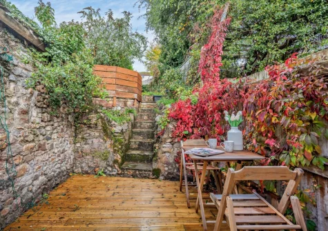 The spacious rear terraced garden & outdoor sitting area at Pippin Cottage, Dawlish