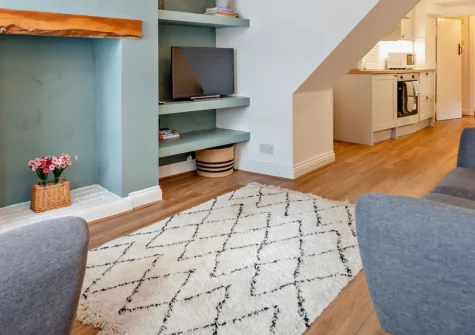 Pippin Cottage, Dawlish is a delightful two-bedroom retreat in the heart of this charming seaside town, featuring a unique four-level terraced garden with rooftop views, contemporary interiors, and Dawlish's sandy beach and famous black swans nearby.