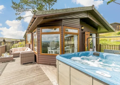 The decked patio, outdoor sitting area & hot tub at Plymouth Sound View, Millbrook