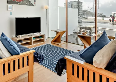 Point Break, Westward Ho! is a stylish ground-floor apartment positioned directly opposite the seafront, featuring floor-to-ceiling windows framing spectacular Lundy Island views, a private ocean-facing terrace, and the beach mere moments away.