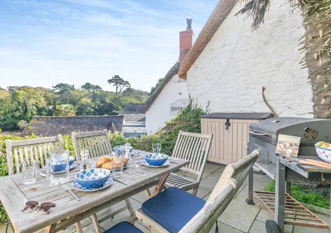 The patio, barbecue & alfresco dining area at Popigale Cottage, Helford