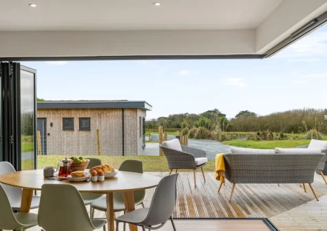 The dining area, the bi-folding doors really open up the space, at Poppyfields at Tremorvu Lodges, Ashton
