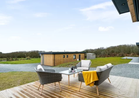 The decked patio & outdoor sitting area at Poppyfields at Tremorvu Lodges, Ashton
