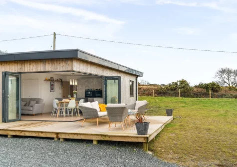 The decked patio, outdoor sitting area & garden at Poppyfields at Tremorvu Lodges, Ashton