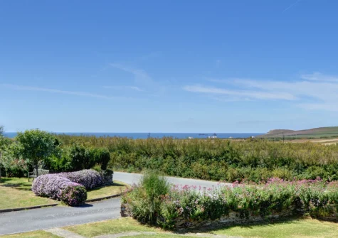 The large shared garden, to the front of the cottage with delightful sea views