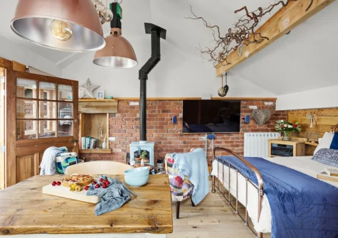The living, dining & sleeping area at Porth Chapel at the Buryas Bridge Collection, Buryas Bridge