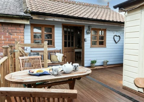 The decked terrace & alfresco dining area at Porth Chapel at the Buryas Bridge Collection, Buryas Bridge