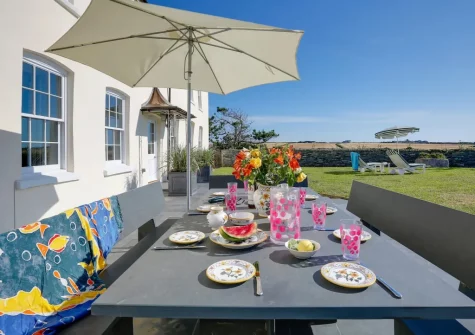 The patio, alfresco dining area & garden at Porthcothan House, Porthcothan