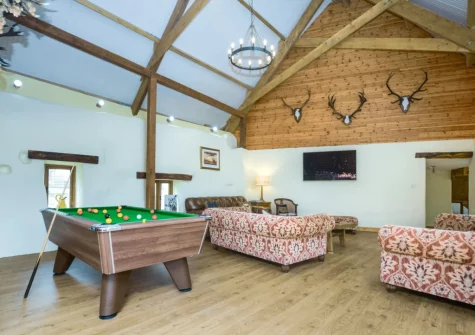 The living room with pool table at Priestacott Tithe Barn, Torrington