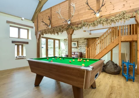 The living room with pool table at Priestacott Tithe Barn, Torrington