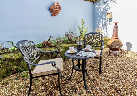 The courtyard & outdoor sitting area at Primrose Cottage at Greatrock Farm, Hennock