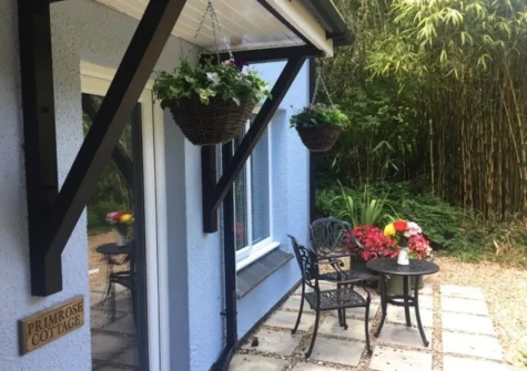 The patio & outdoor sitting area at Primrose Cottage at Greatrock Farm, Hennock