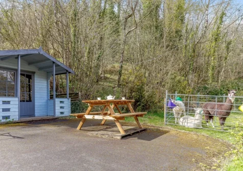 The shared outdoor sitting area at Primrose Cottage at Greatrock Farm, Hennock