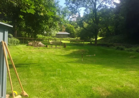 The shared croquet lawn at Primrose Cottage at Greatrock Farm, Hennock