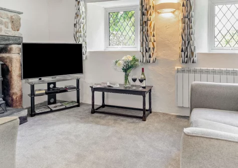 Primrose Cottage, Camelford is a cosy two-bedroom retreat for three-guests, on the edge of Bodmin Moor, featuring characterful beams, a sunny patio for alfresco dining, and direct access to moorland walks and the dramatic North Cornwall coastline.