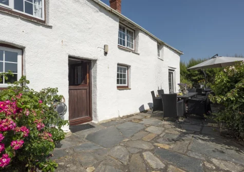 The terrace, alfresco dining area & garden at Primrose Cottage, Treyarnon