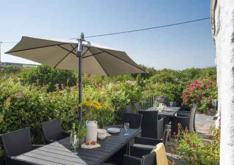 The terrace, barbecue & alfresco dining area at Primrose Cottage, Treyarnon