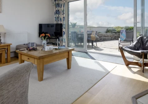 Puffins at Ocean Blue, Treyarnon is a stylish ground-floor apartment with stunning sea views, sleeping six across three bedrooms (two en-suite), plus a private terrace, allocated parking and the golden sands of Treyarnon Bay just steps away.