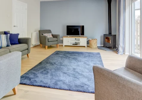Puffins Retreat, Braunton is a bright three-bedroom home in this vibrant North Devon village, featuring stylish modern interiors, a wood-burning stove, and an enclosed patio garden, with Saunton's sands and Croyde's surf just moments away.