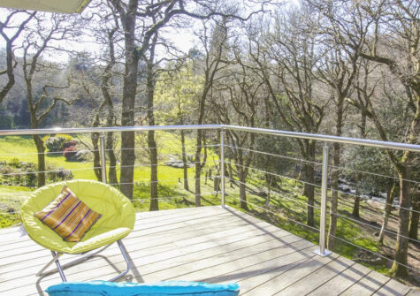 The tree house's wrap around balcony at Puggiestone House, Chagford
