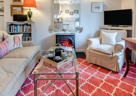 Pyworthy Cottage, North Tamerton is a peaceful retreat set within beautiful rectory grounds in rural Cornwall, featuring open-plan living spaces, a private patio with countryside views, and easy access to both dramatic coastline and moorland.