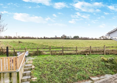The rear garden & elevated terrace, barbecue & alfresco dining area at Quarry Cottage, Veryan