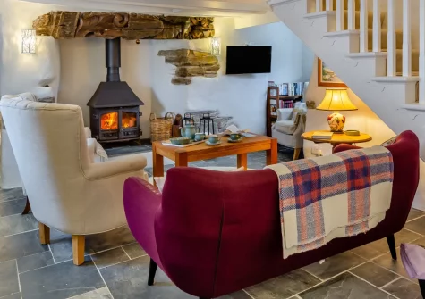 Quarry Cottage, Veryan is a quintessential Cornish retreat on the peaceful Roseland Peninsula, featuring characterful interiors with wood burner, sun-drenched terraces with rural views, and dog-friendly walks to hidden coves and sandy beaches.