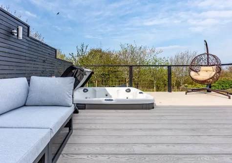 The decked patio, outdoor sitting area & hot tub at Quay West, Lee