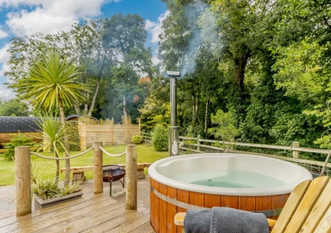 The terrace, outdoor sitting area & hot tub at River Avon Retreat, Avonwick