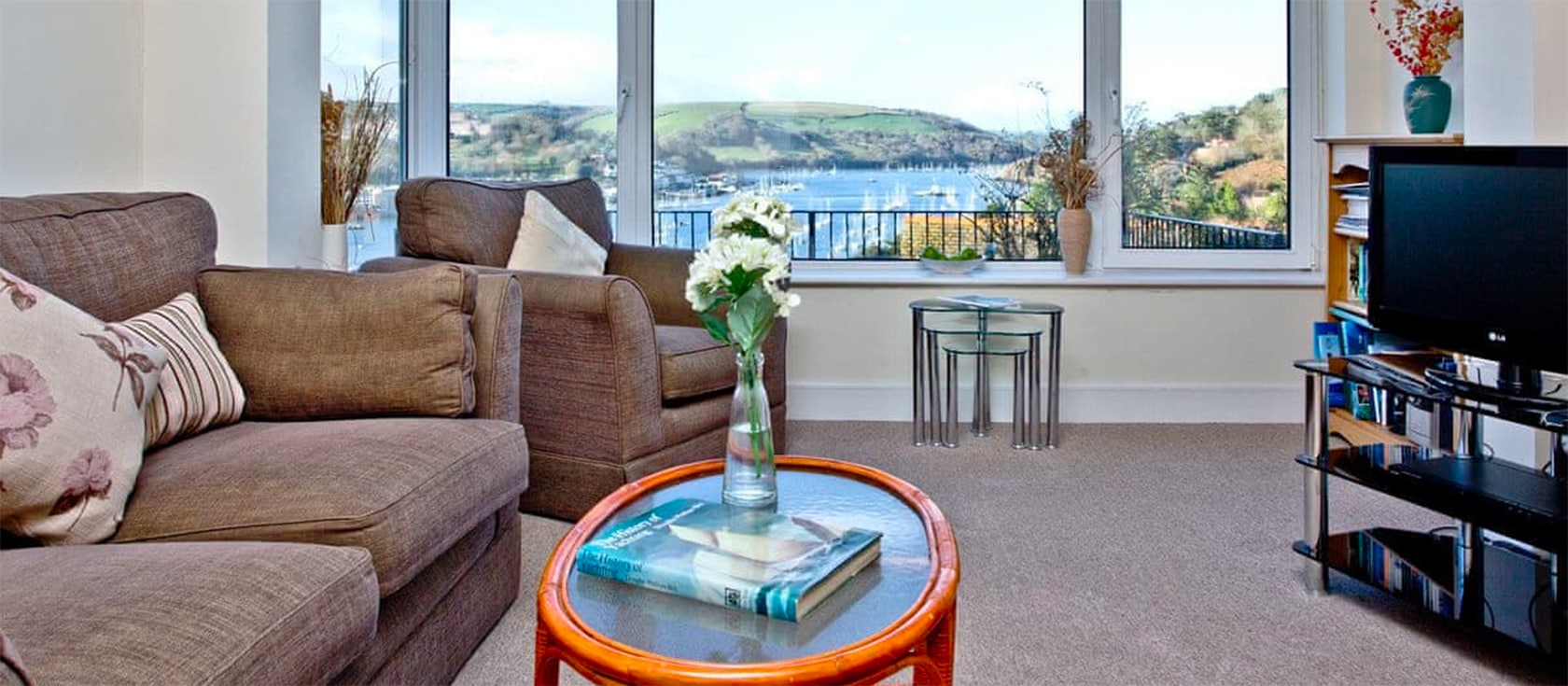River Cottage is a well-appointed two bedroom house in Kingswear with stunning views across the river to Dartmouth. In a peaceful setting and close to local beaches, the house has a Victorian-style open fireplace and an outdoor patio.