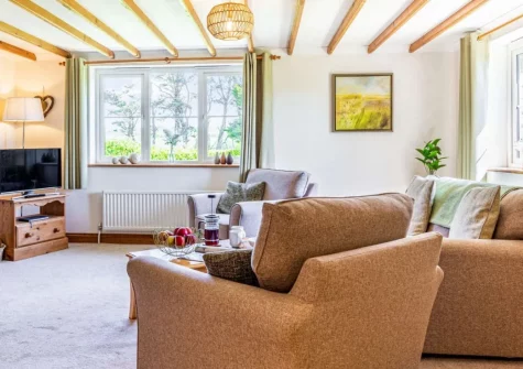 Riverside, Marazion is a charming contemporary ground-floor farmhouse apartment with open-plan living, characterful exposed beams, and a beautiful enclosed garden, just one mile from the iconic St Michael's Mount and Cornwall's glorious coast.