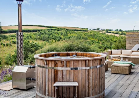 The wood-fired hot tub & decked patio at Riverview Farmhouse, Paynter's Cross