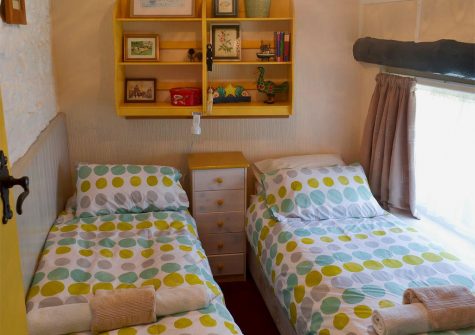Bedroom #2 with two single beds at Robin Cottage, Brixham
