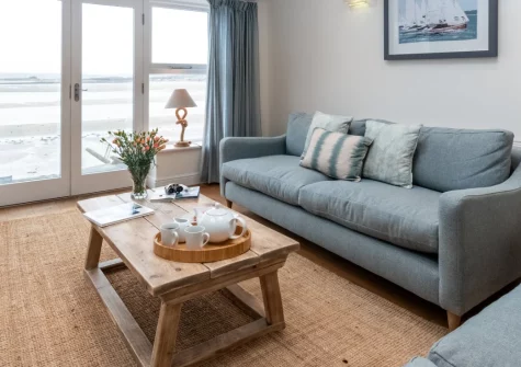 Rock Rose Cottage, Appledore is a beautifully renovated three-bedroom character retreat overlooking the estuary, with contemporary interiors, floor-to-ceiling windows with stunning water views, & a sunny courtyard garden perfect for relaxation.